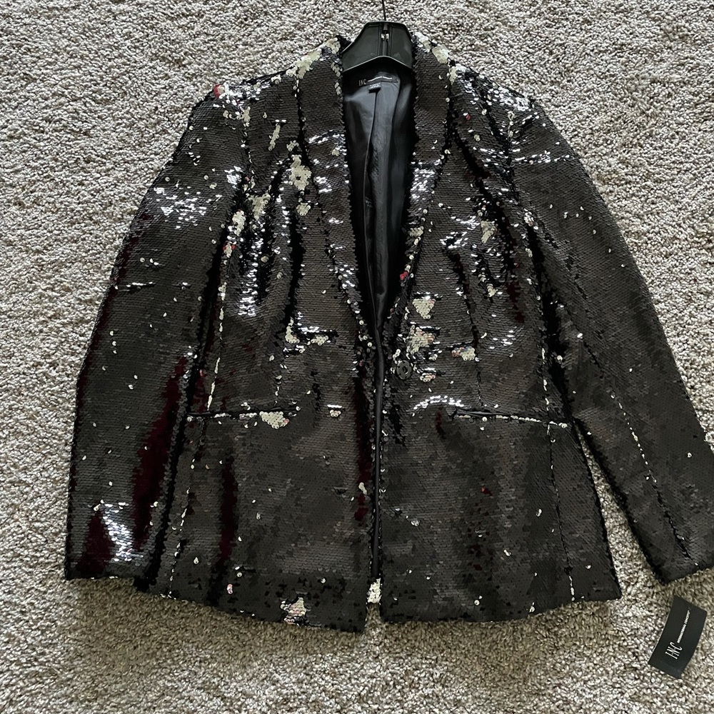 Black sequins blazer runs on the larger side